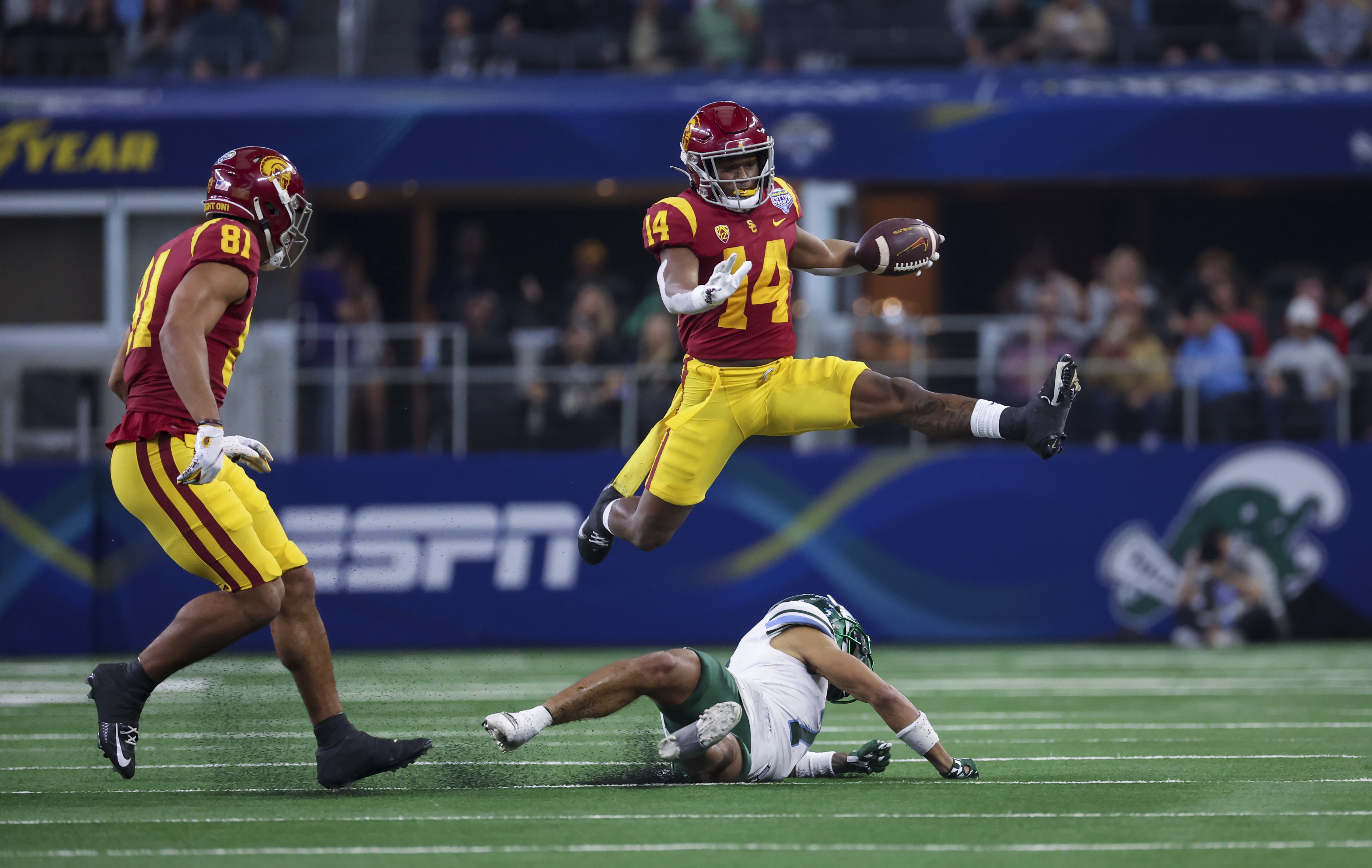 USC Trojans wide receiver Raleek Brown hurdles a Tulane defender.